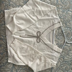 Chic Cream Sweater with Chain Accent